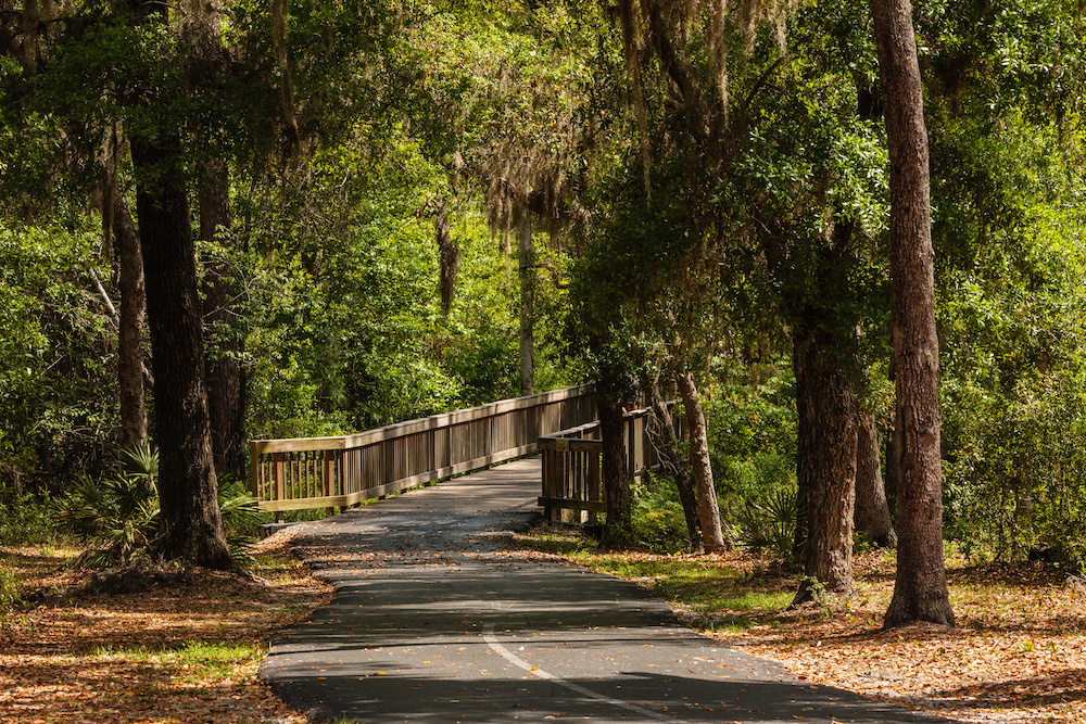 Paved bike trail through the different vegetation at Gulf State Park, Gulf Shores, Alabama